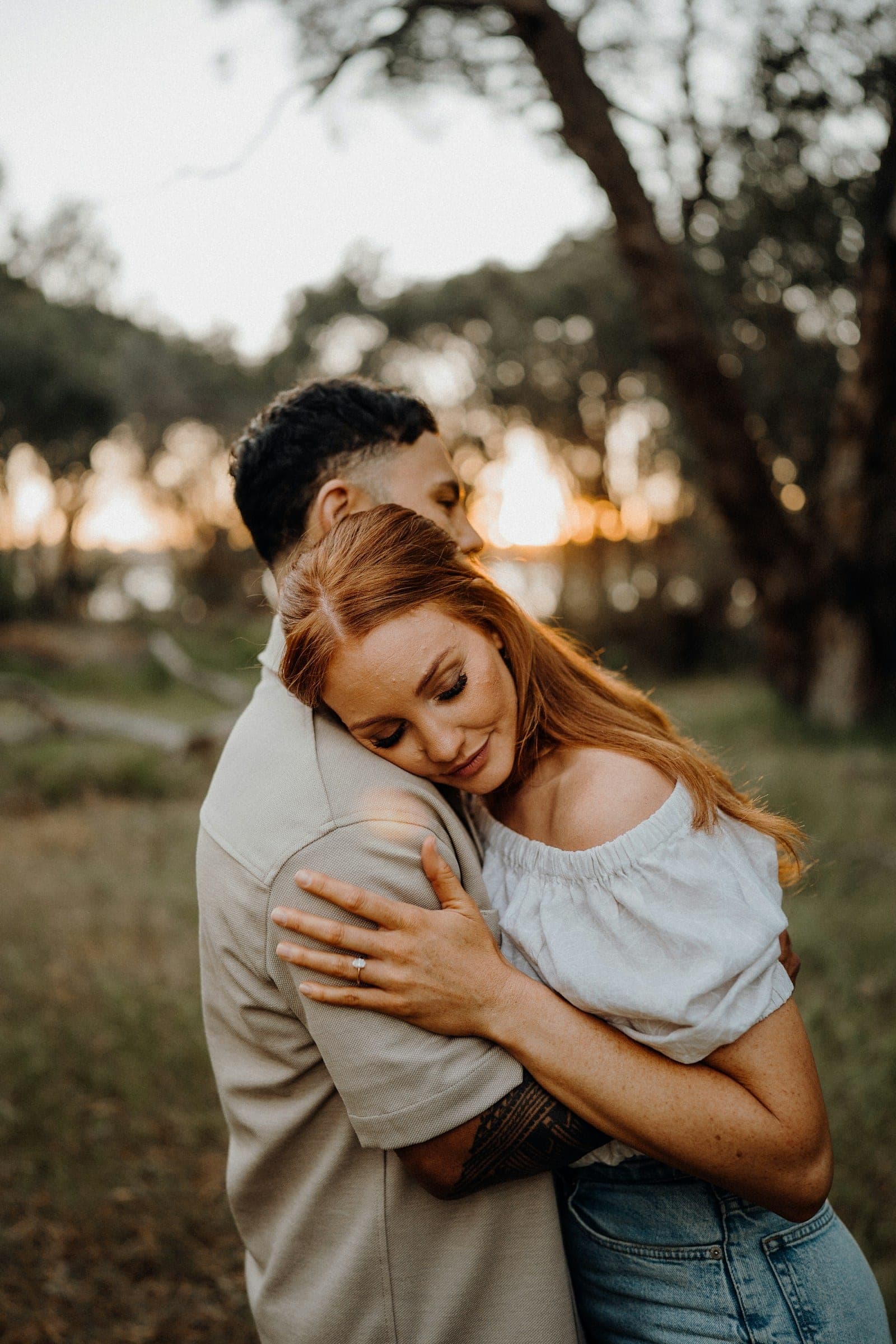 A couple holding each other at sunset